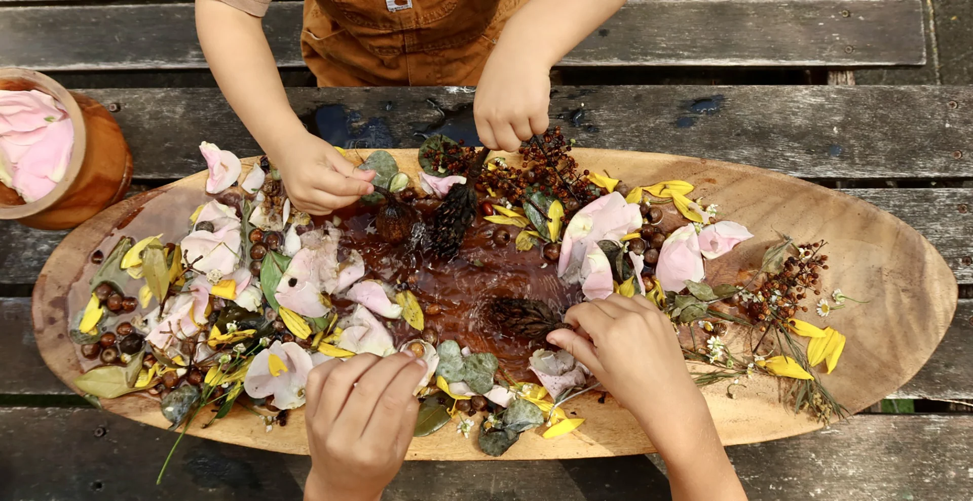 Children decorating a nature platter during play-based learning at Sunshine Mini School childcare
