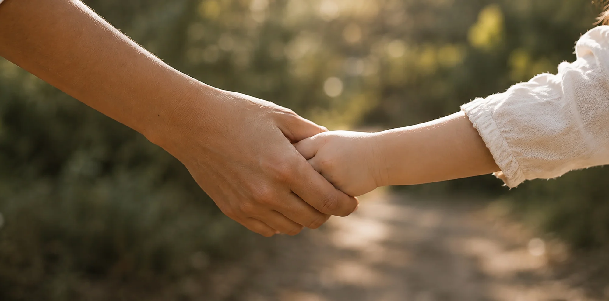 Educator holding a child's hand at Sunshine Mini School, family-owned childcare in Tingalpa